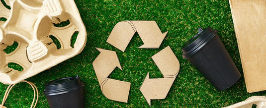 Recyclable sign made from craft paper surrounded by sustainable packaging